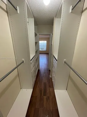 a view of staircase with wooden floor and railing