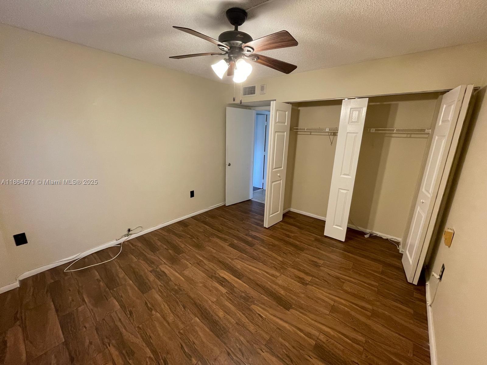4164 Inverrary Drive, Unit 215 Lauderhill, FL 33319 - Photo 24 of 27 wooden floor in an empty room with a window
