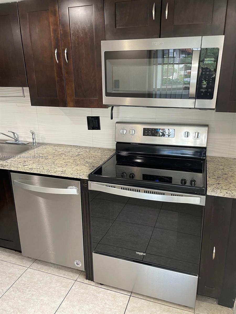 4164 Inverrary Drive, Unit 215 Lauderhill, FL 33319 - Photo 3 of 27 a stove top oven sitting inside of a kitchen