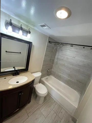 a bathroom with a sink a toilet and bathtub