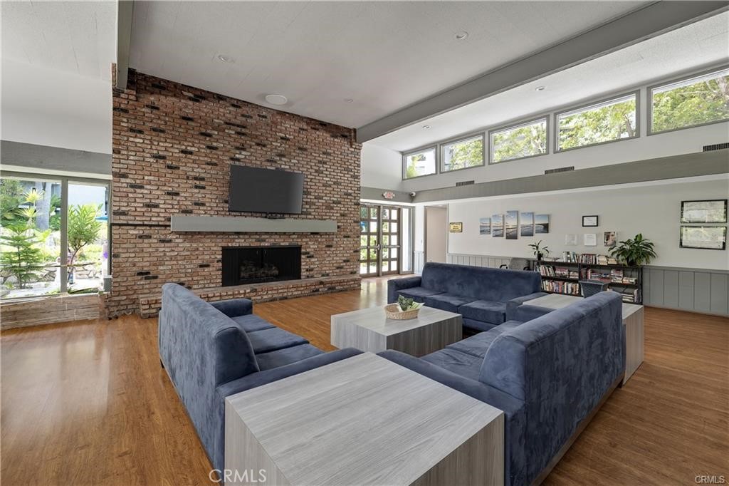 3605 West Hidden Lane, Unit 309 Rolling Hills Estates, CA 90274 - Photo 25 of 37 a living room with furniture large window and a fireplace