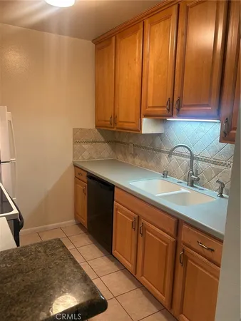a kitchen with a sink cabinets and wooden floor
