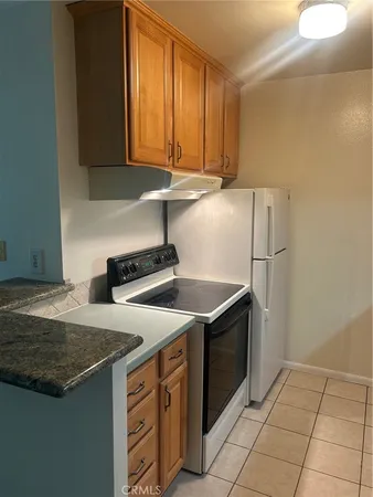 a kitchen with a stove and a refrigerator