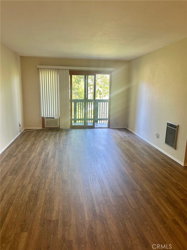 3605 West Hidden Lane, Unit 309 Rolling Hills Estates, CA 90274 - Photo 9 of 37 a view of an empty room with wooden floor and a window