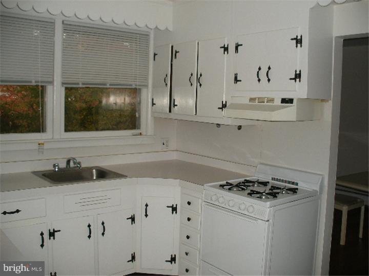 206 East Providence Road Yeadon, PA 19050 - Photo 8 of 25 a kitchen with granite countertop a sink stove and cabinets