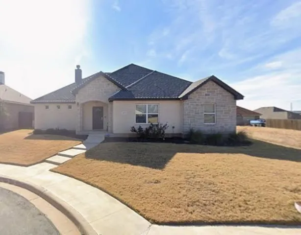 a front view of a house with yard