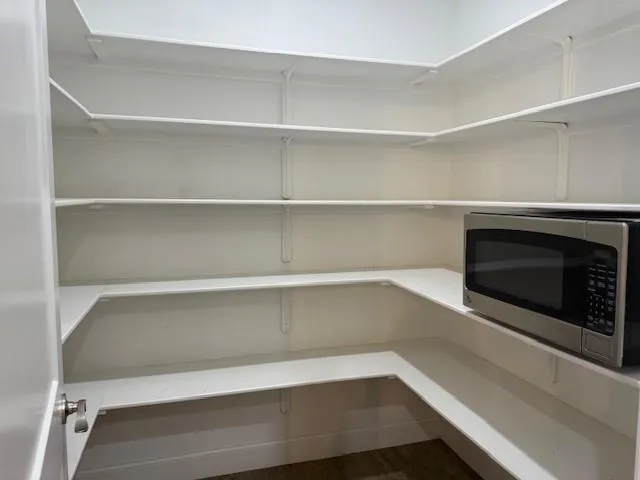 a view of an empty room with a fireplace