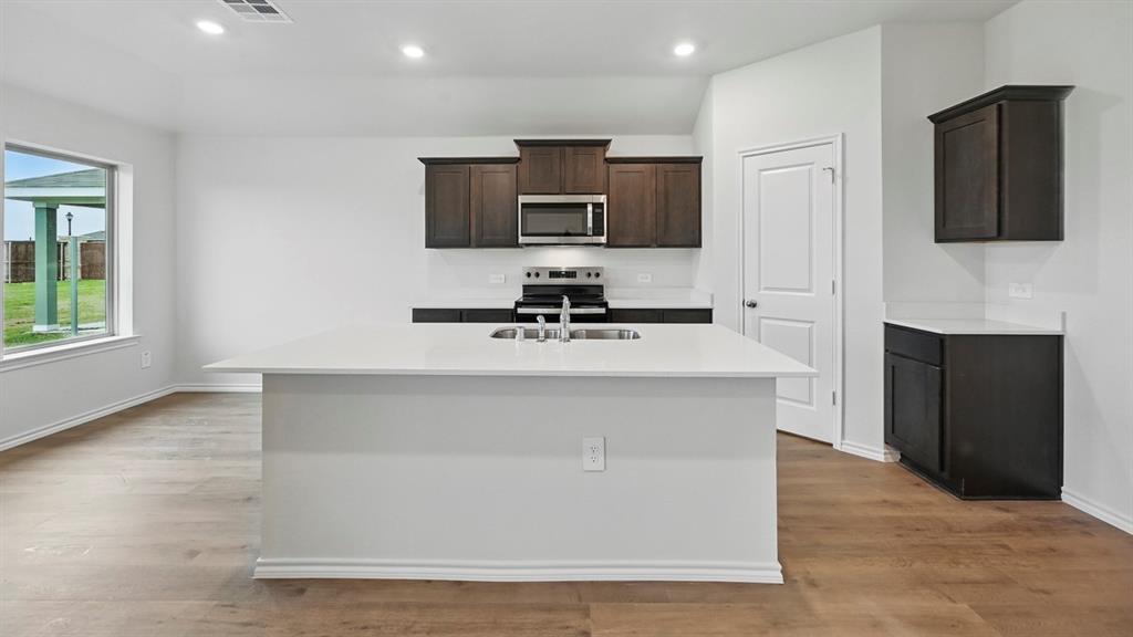 511 Lantana Road Princeton, TX 75407 - Photo 19 of 35 a view of kitchen with stainless steel appliances a sink and a microwave