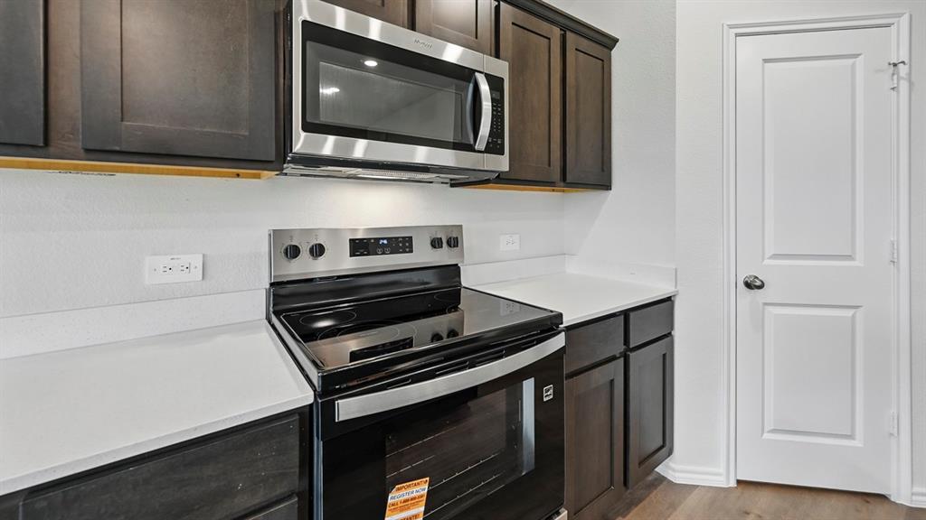 511 Lantana Road Princeton, TX 75407 - Photo 25 of 35 a kitchen with wooden cabinets and a stove top oven