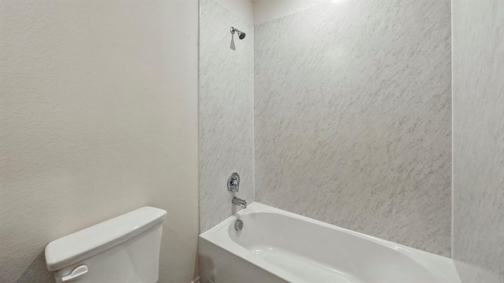 511 Lantana Road Princeton, TX 75407 - Photo 5 of 35 a bathroom with a bathtub and toilet