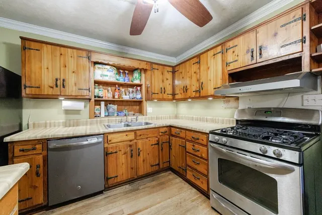 a kitchen with stainless steel appliances granite countertop a stove and a sink