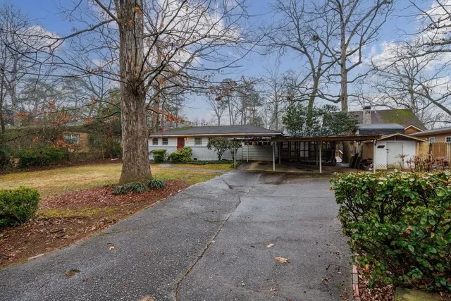 a view of house with outdoor space and garden