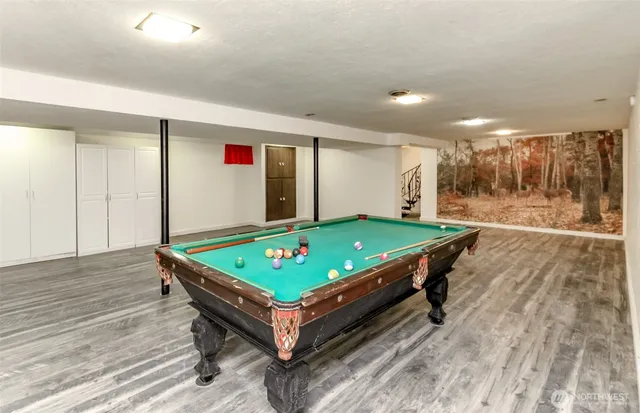 a room with pool table table tennis pool table and windows