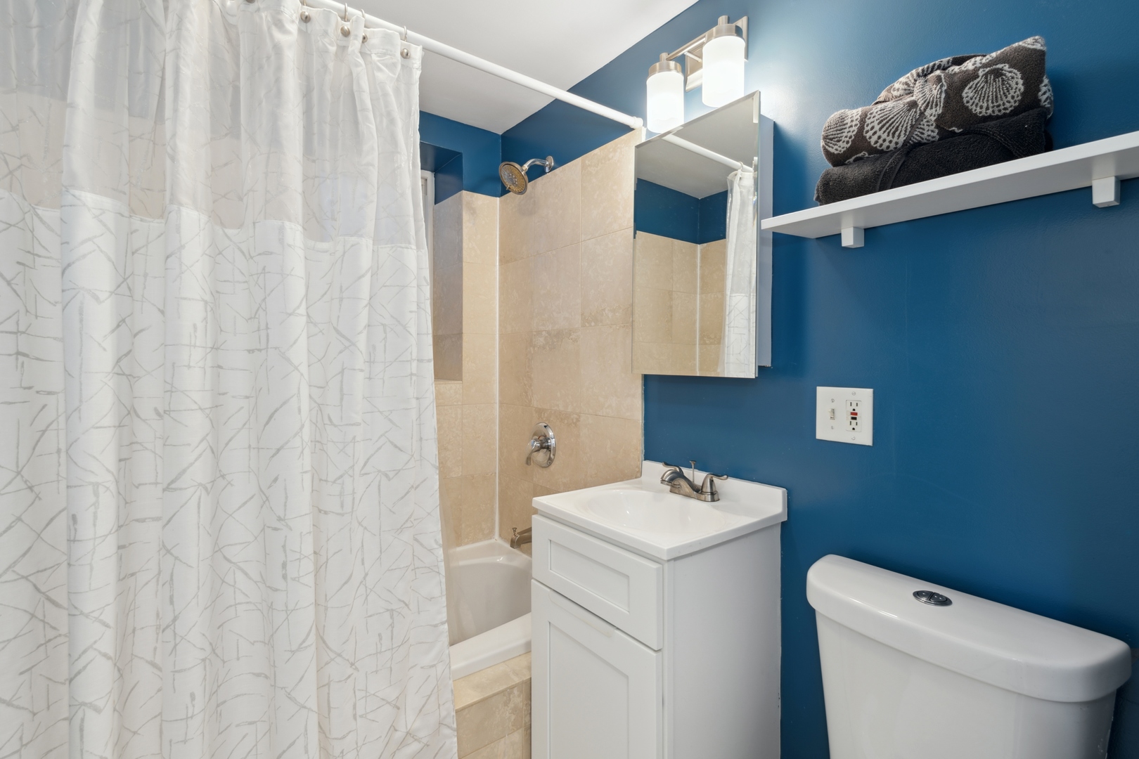 3845 West Altgeld Street, Unit G Chicago, IL 60647 - Photo 12 of 15 a bathroom with a sink toilet and shower