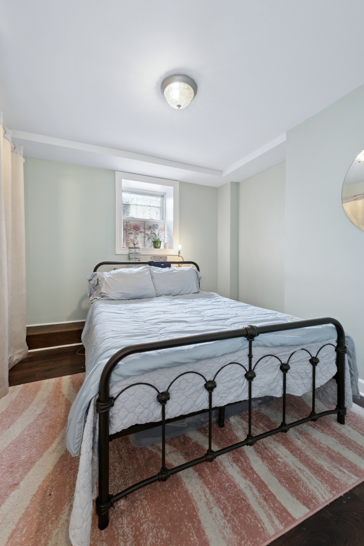 3845 West Altgeld Street, Unit G Chicago, IL 60647 - Photo 8 of 15 a bedroom with a bed and window