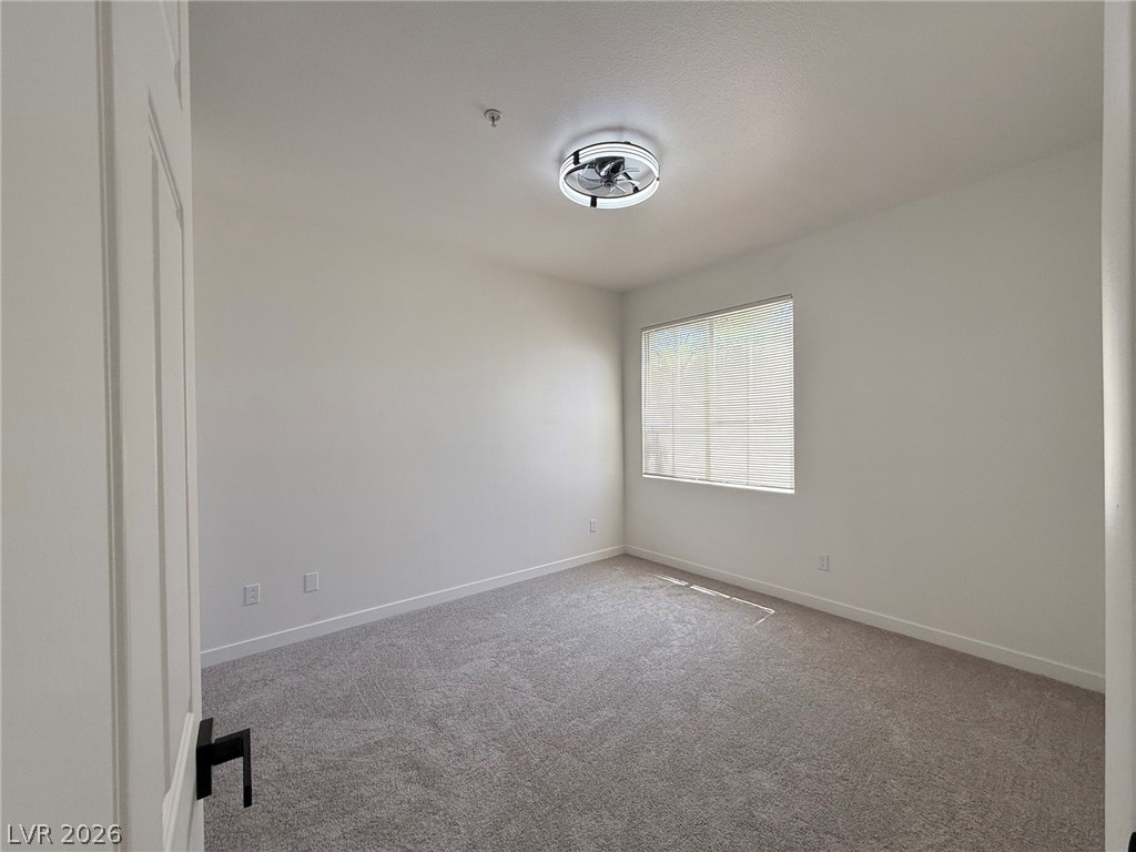9050 West Warm Springs Road, Unit 2002 Las Vegas, NV 89148 - Photo 31 of 46 An inviting room awaits your personal touch, offering comfort and style.