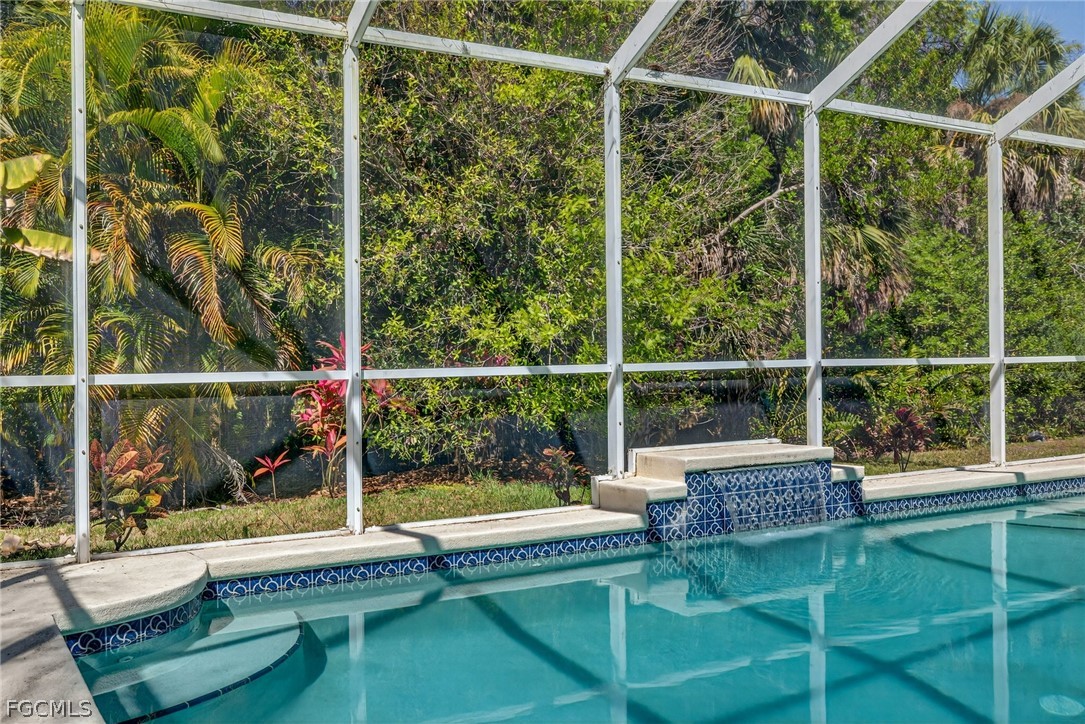 22866 Forest Ridge Drive Estero, FL 33928 - Photo 31 of 38 a view of a balcony with floor to ceiling windows and wooden fence