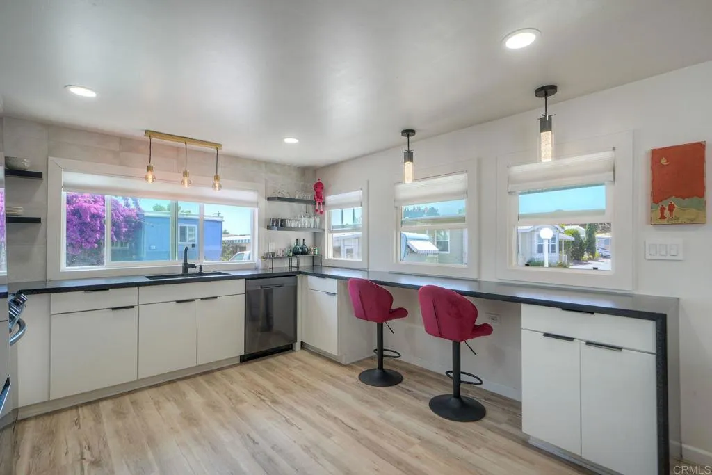 699 North Vulcan Avenue, Unit 6 Encinitas, CA 92024 - Photo 11 of 27 a kitchen with a sink cabinets and wooden floor