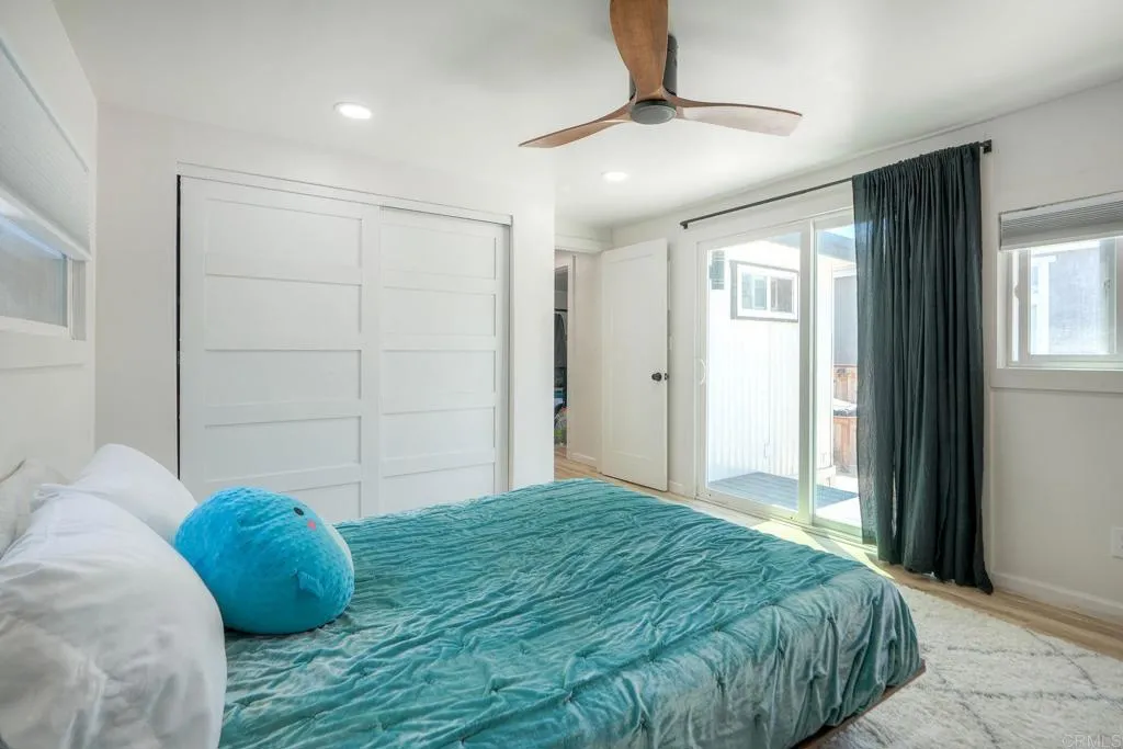699 North Vulcan Avenue, Unit 6 Encinitas, CA 92024 - Photo 17 of 27 a bedroom with a bed and a window
