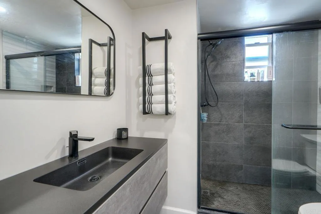 699 North Vulcan Avenue, Unit 6 Encinitas, CA 92024 - Photo 18 of 27 a bathroom with a sink and a mirror