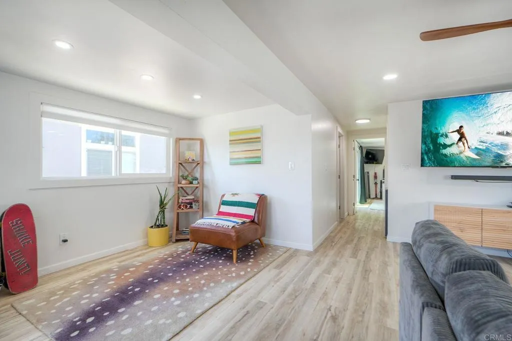 699 North Vulcan Avenue, Unit 6 Encinitas, CA 92024 - Photo 4 of 27 a living room with furniture and a flat screen tv