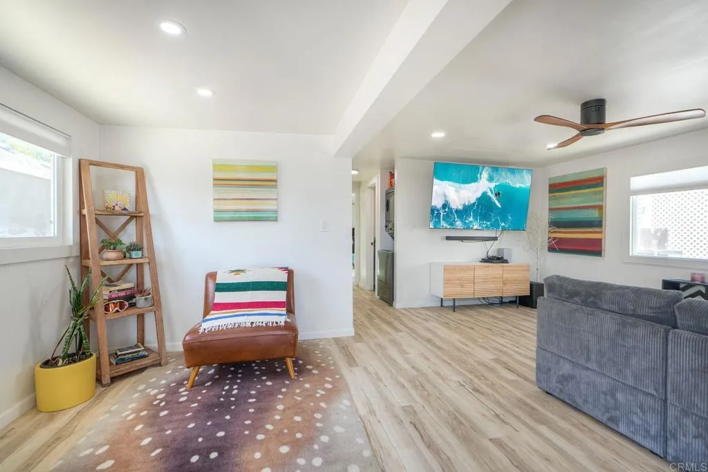 699 North Vulcan Avenue, Unit 6 Encinitas, CA 92024 - Photo 5 of 27 a bedroom with furniture and a book shelf