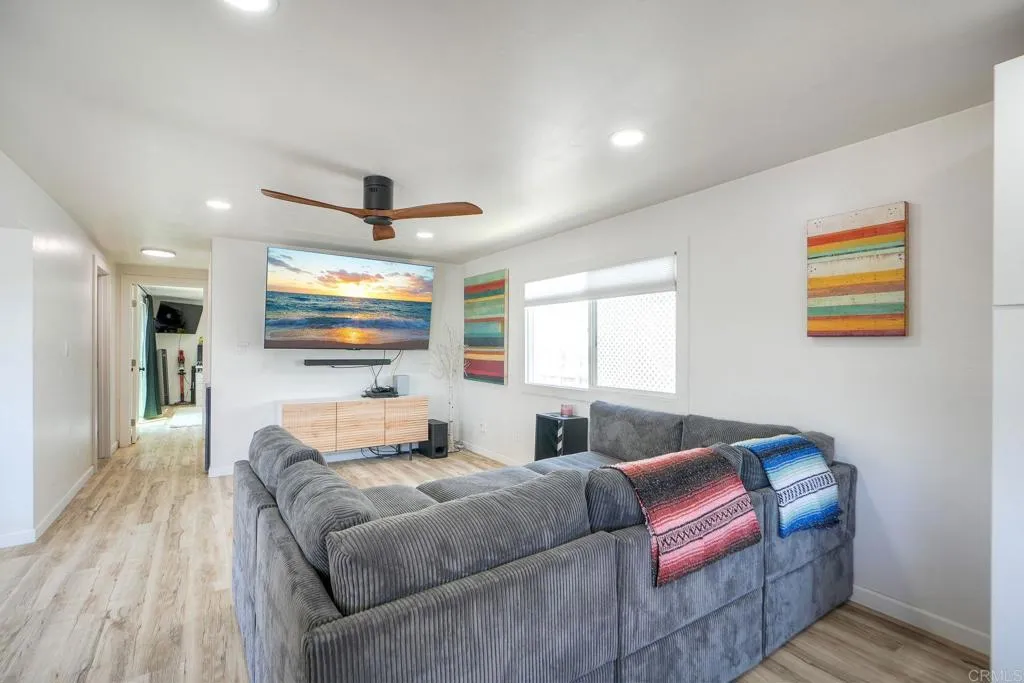 699 North Vulcan Avenue, Unit 6 Encinitas, CA 92024 - Photo 7 of 27 a bedroom with a bed and wooden floor