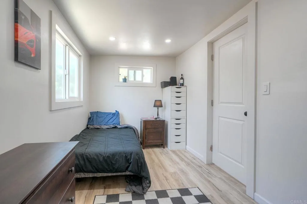 699 North Vulcan Avenue, Unit 6 Encinitas, CA 92024 - Photo 9 of 27 a bedroom with a bed and a window