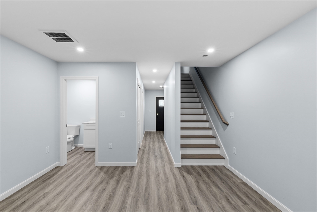 75 Hunter Street Fall River, MA 02721 - Photo 11 of 14 a view of a hallway with wooden floor and stairs