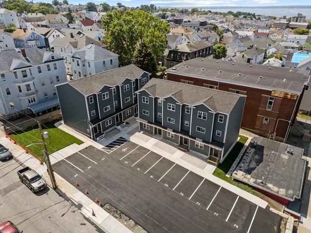 an aerial view of a house with a backyard
