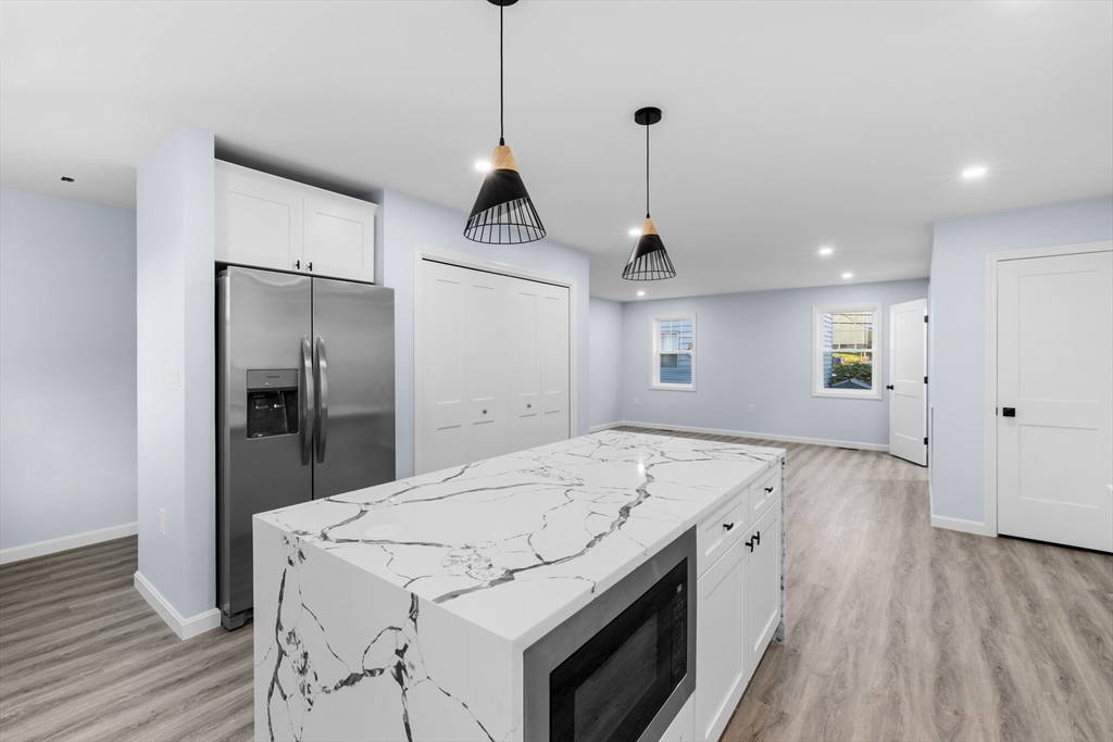75 Hunter Street Fall River, MA 02721 - Photo 6 of 14 a view of a kitchen with a sink a refrigerator and wooden floor