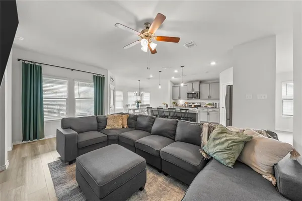a living room with furniture and kitchen view