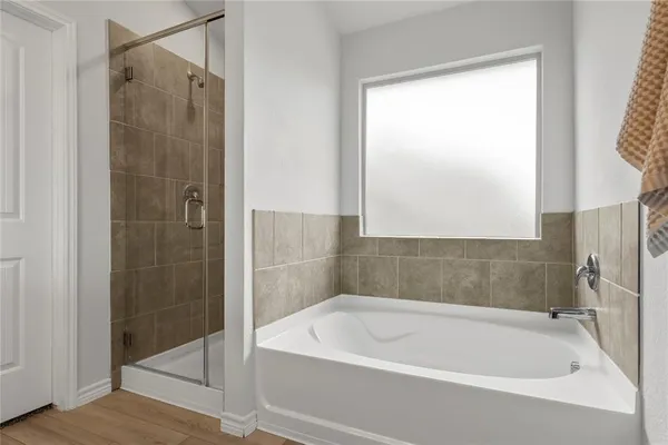 a white bath tub sitting next to a shower