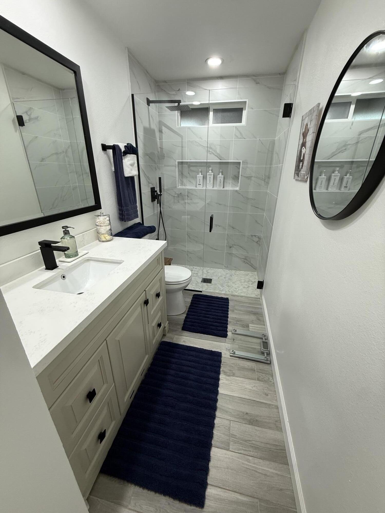 37081 Palmdale Road Rancho Mirage, CA 92270 - Photo 35 of 46 a bathroom with a sink a toilet a mirror and shower