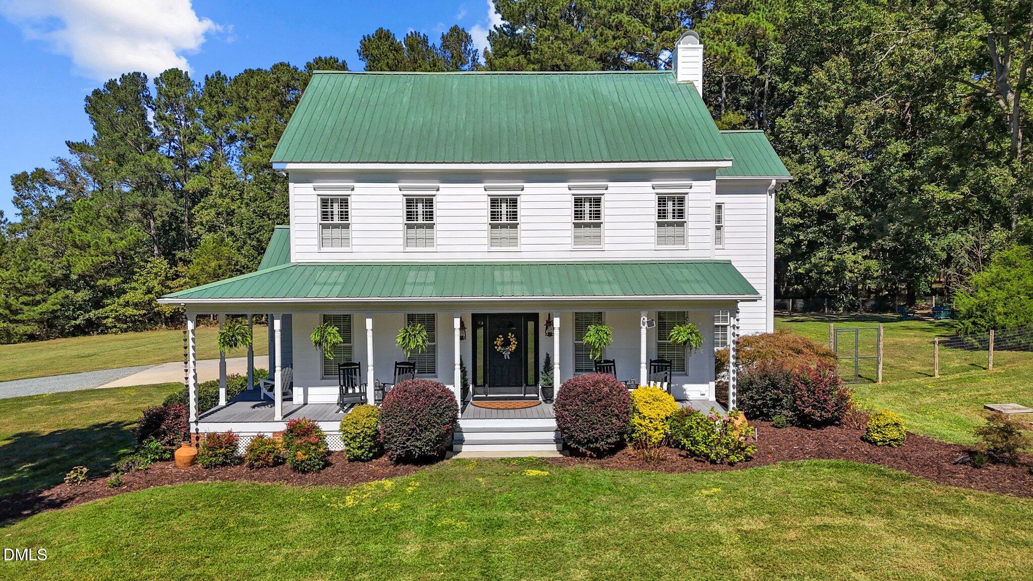 a view of a house with backyard porch and sitting area