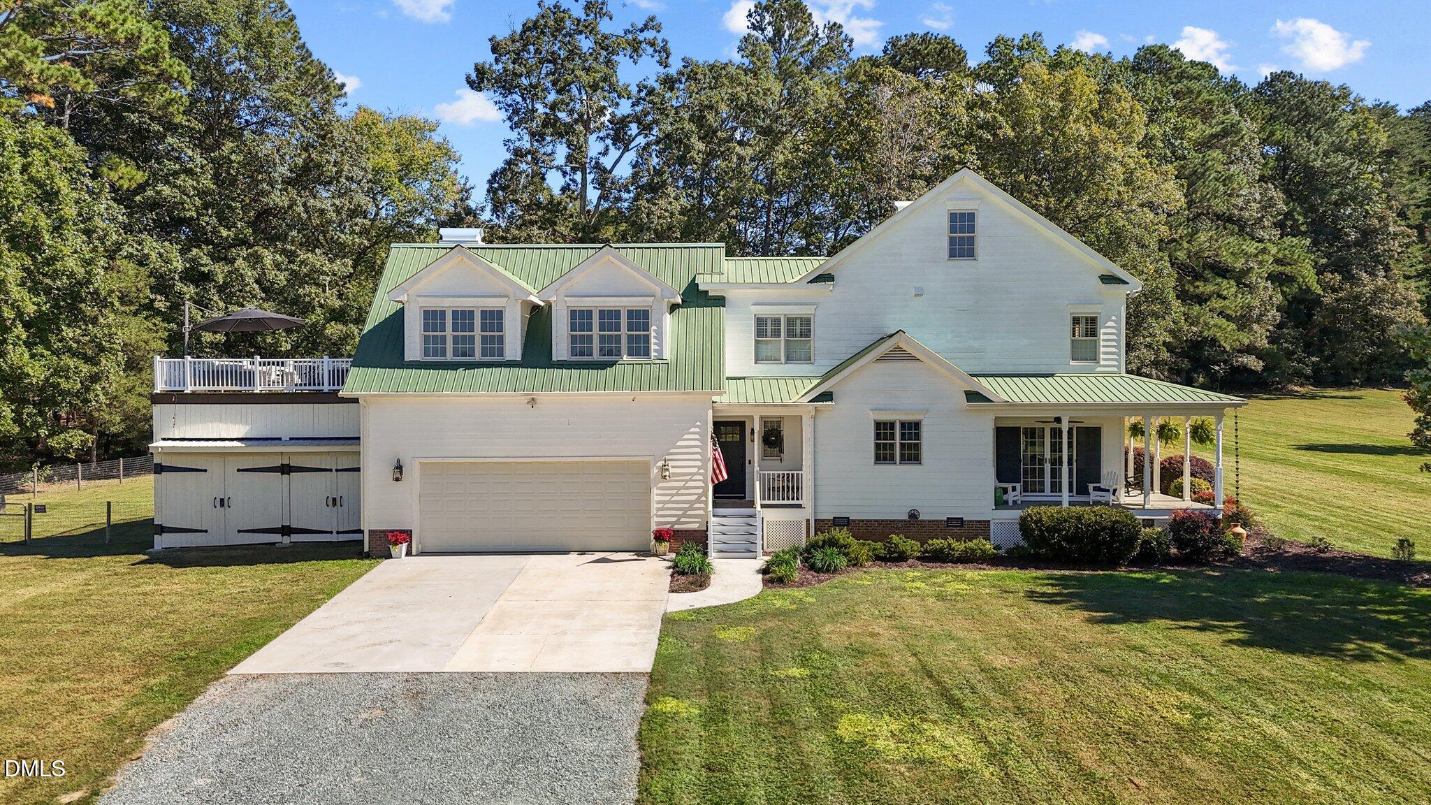 220 Epps Clark Road Siler City, NC 27344 - Photo 2 of 55 a front view of a house with a yard and garage