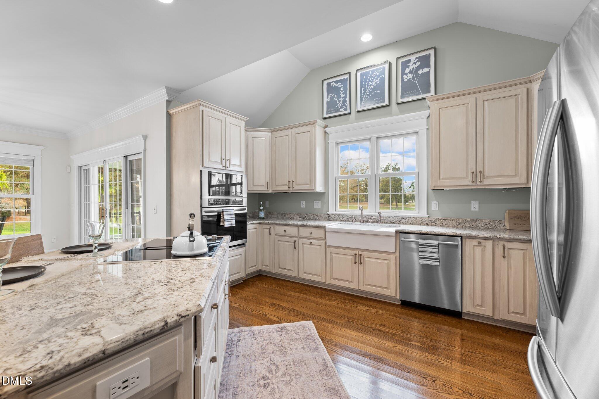220 Epps Clark Road Siler City, NC 27344 - Photo 29 of 55 a kitchen with stainless steel appliances granite countertop a stove a sink and a refrigerator