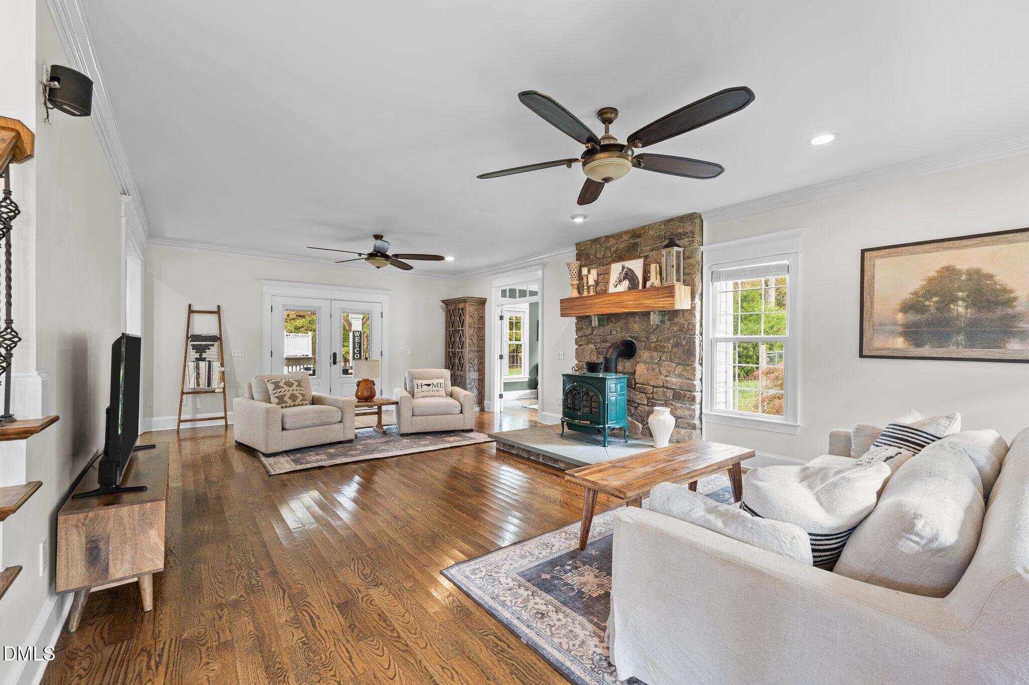 220 Epps Clark Road Siler City, NC 27344 - Photo 34 of 55 a living room with fireplace furniture and a wooden floor