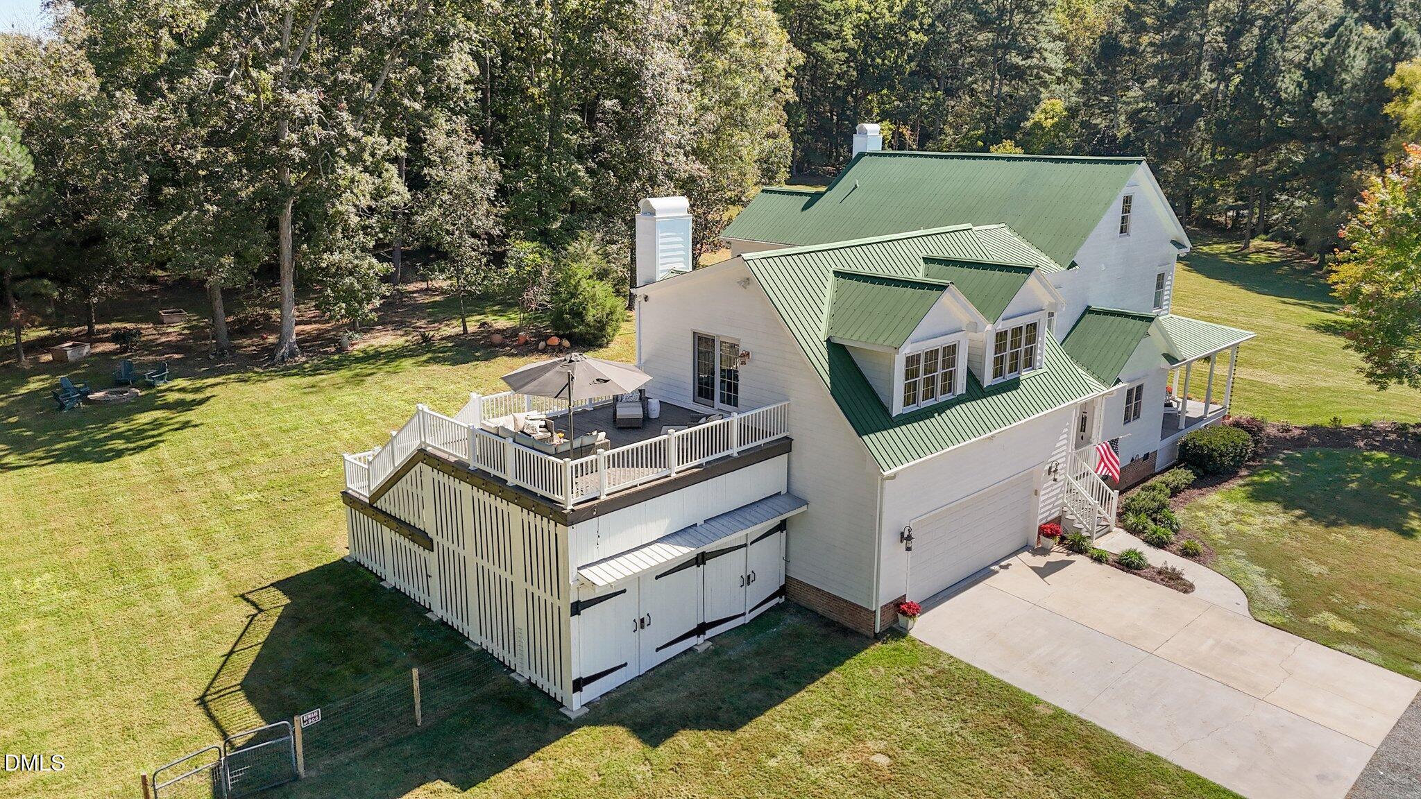 220 Epps Clark Road Siler City, NC 27344 - Photo 4 of 55 an aerial view of a house with swimming pool and large trees