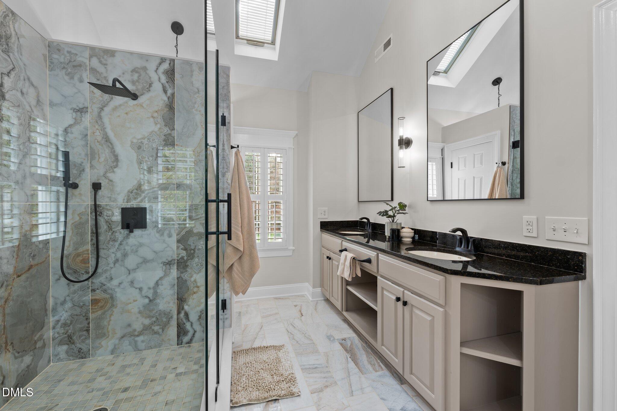 220 Epps Clark Road Siler City, NC 27344 - Photo 42 of 55 a bathroom with a granite countertop shower a mirror and a sink