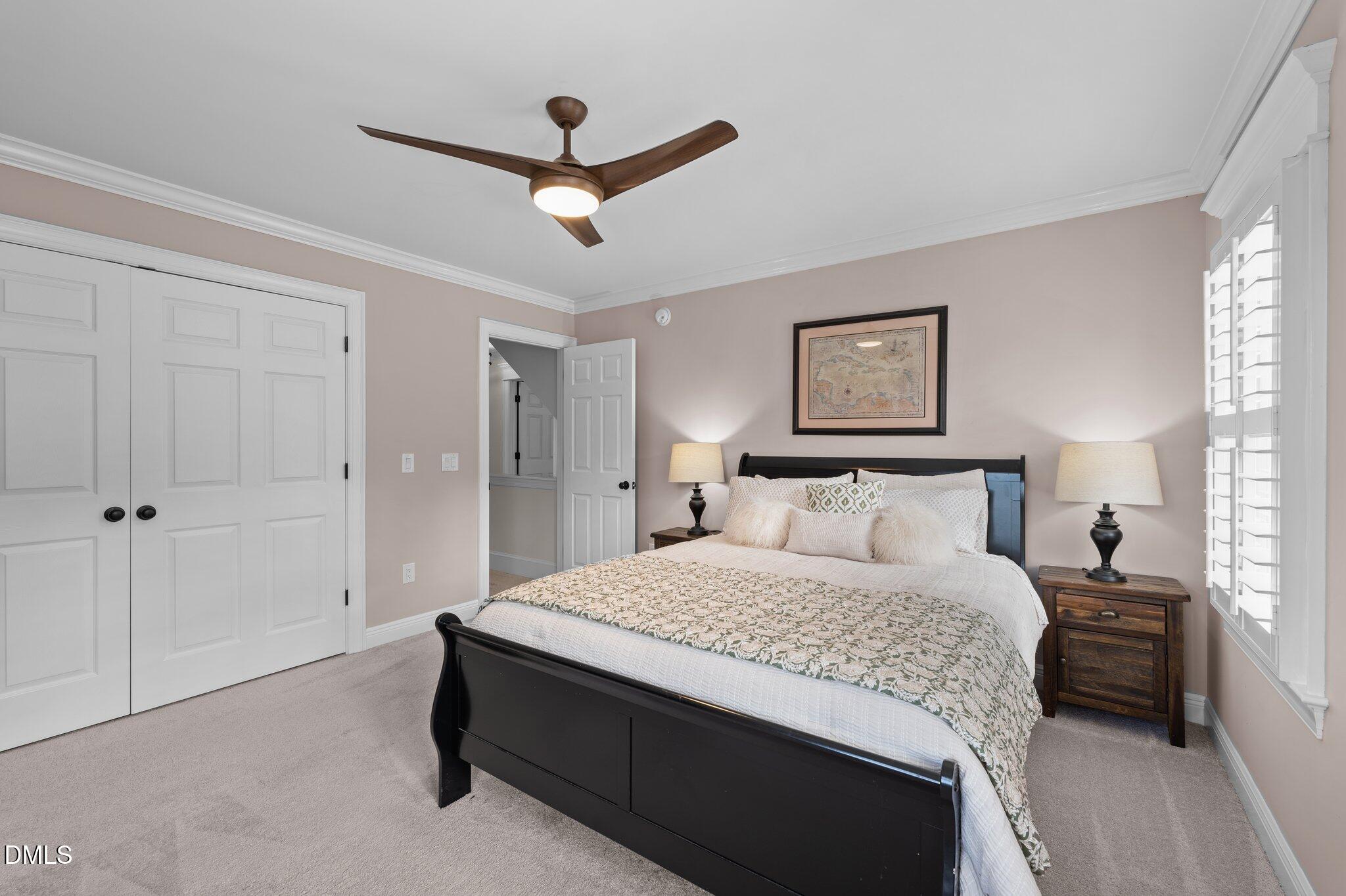 220 Epps Clark Road Siler City, NC 27344 - Photo 44 of 55 a bedroom with a large bed and a ceiling fan