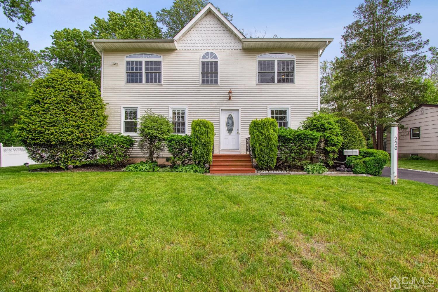 a front view of a house with a garden