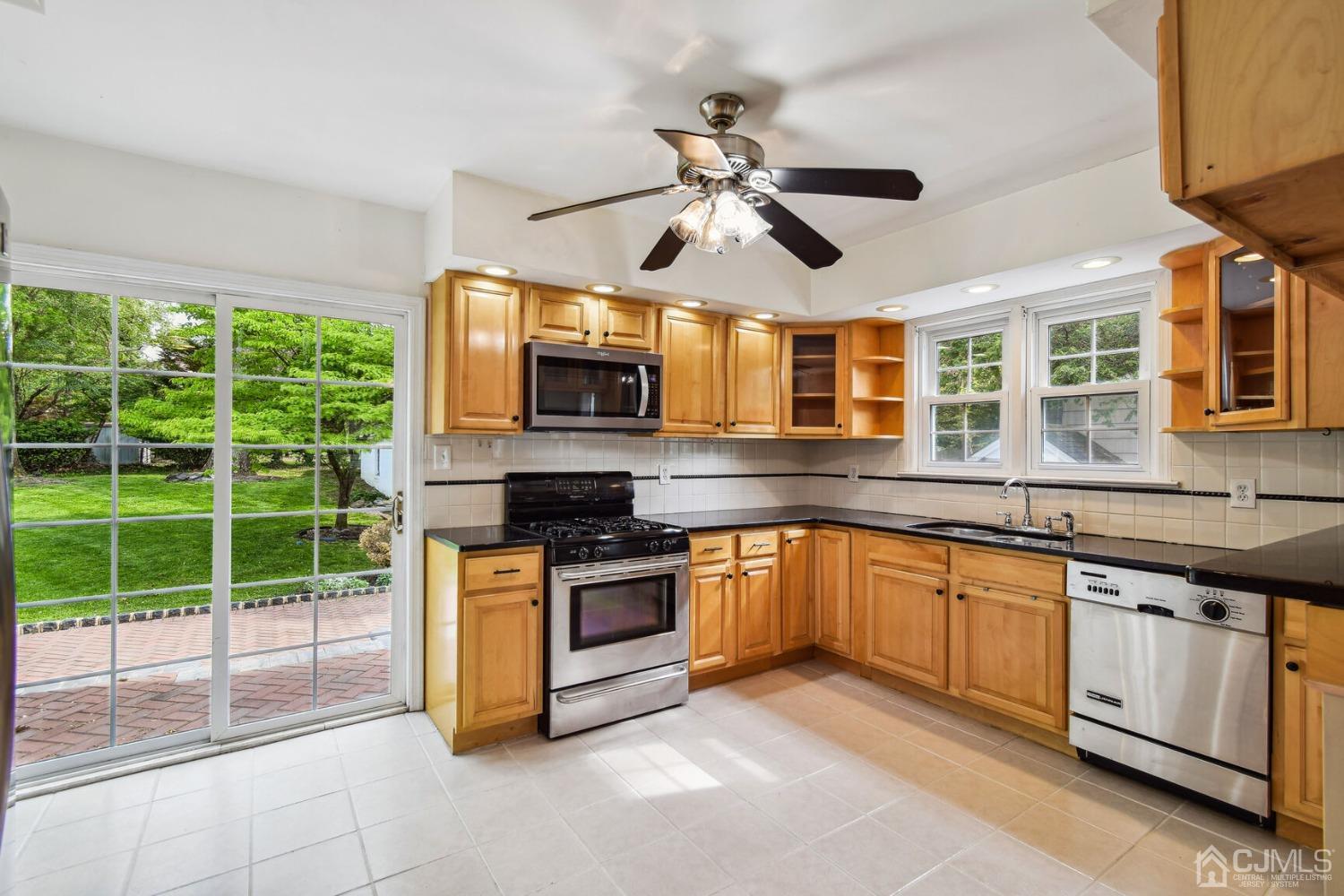220 Dunhams Corner Road East Brunswick, NJ 08816 - Photo 11 of 27 a kitchen with stainless steel appliances granite countertop a stove and a sink