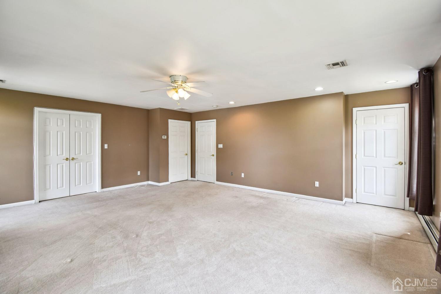 220 Dunhams Corner Road East Brunswick, NJ 08816 - Photo 13 of 27 a view of an empty room with a ceiling fan