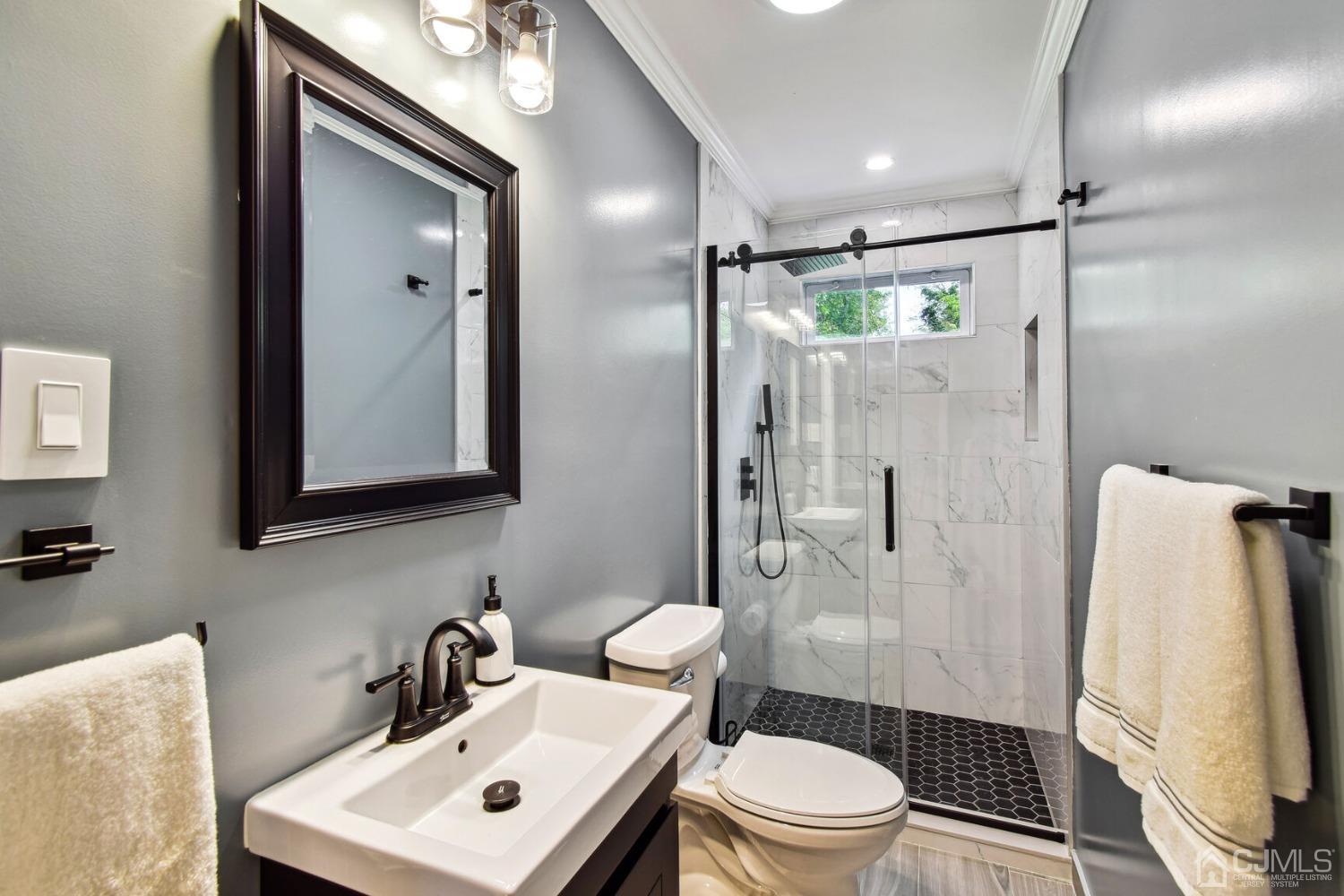 220 Dunhams Corner Road East Brunswick, NJ 08816 - Photo 18 of 27 a bathroom with a sink toilet and shower