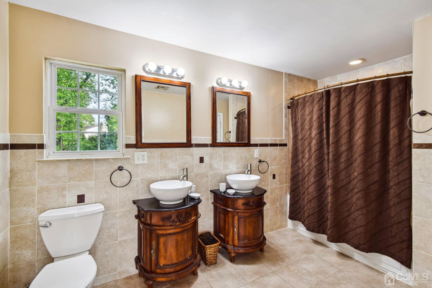 220 Dunhams Corner Road East Brunswick, NJ 08816 - Photo 19 of 27 a bathroom with a toilet a sink and a mirror