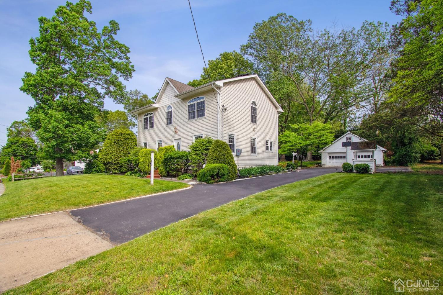 220 Dunhams Corner Road East Brunswick, NJ 08816 - Photo 3 of 27 a front view of a house with garden