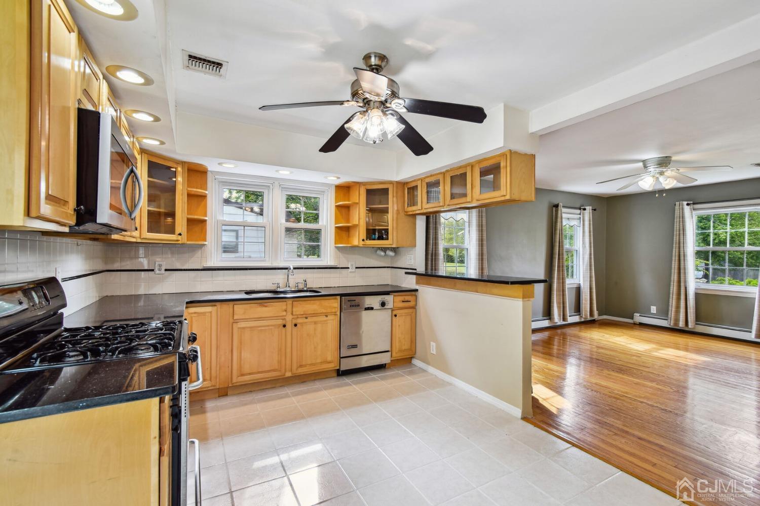 220 Dunhams Corner Road East Brunswick, NJ 08816 - Photo 10 of 27 a kitchen with stainless steel appliances granite countertop a sink and cabinets