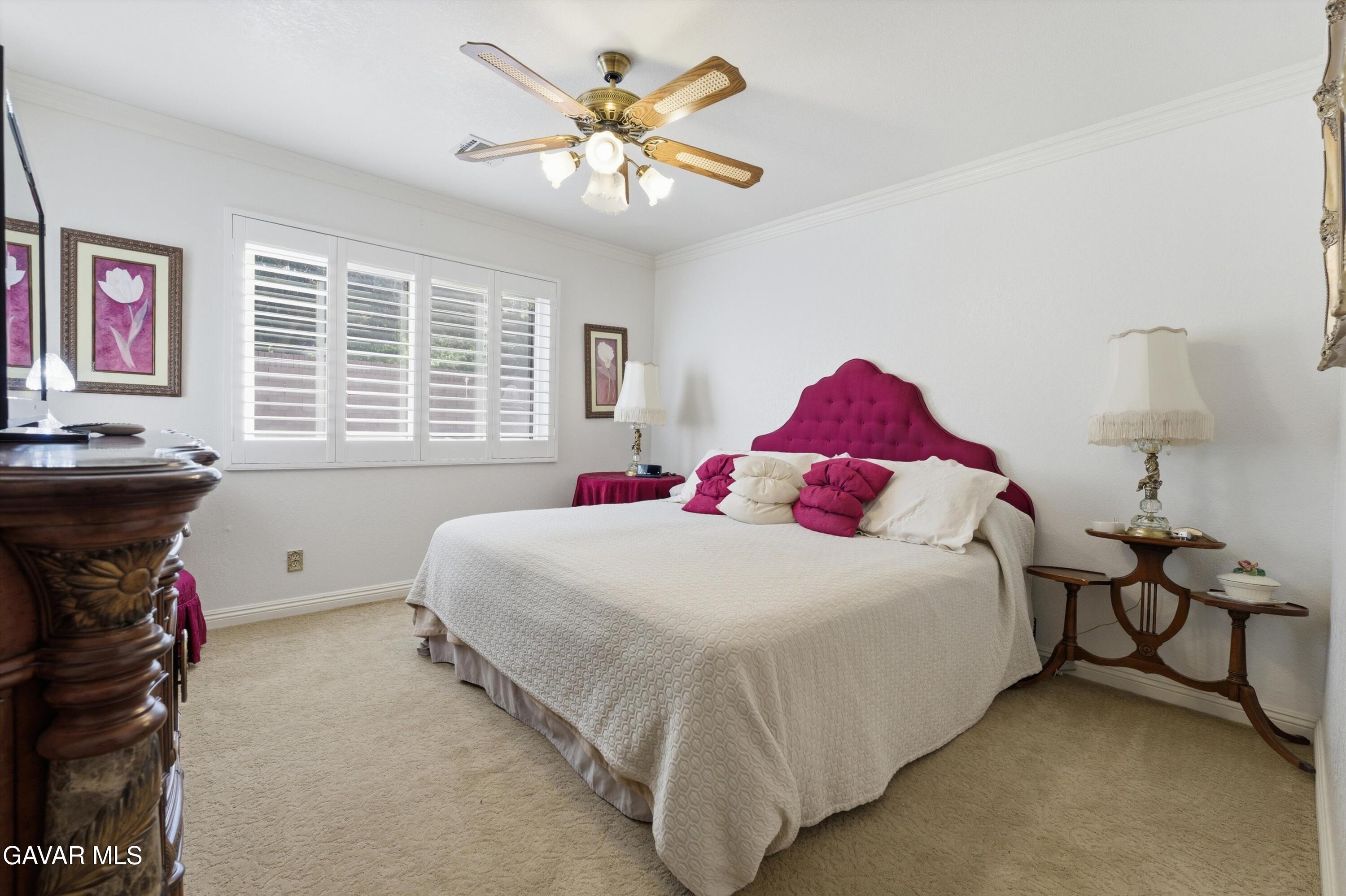 5801 Hacienda Ranch Road Palmdale, CA 93551 - Photo 32 of 69 a bedroom with a bed and a chandelier
