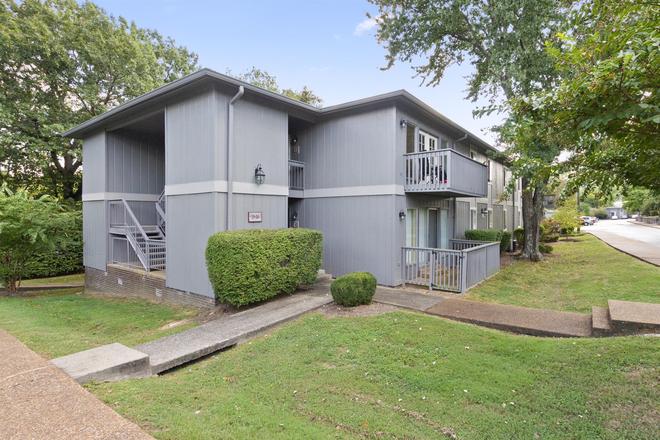 a view of a house with a yard and porch